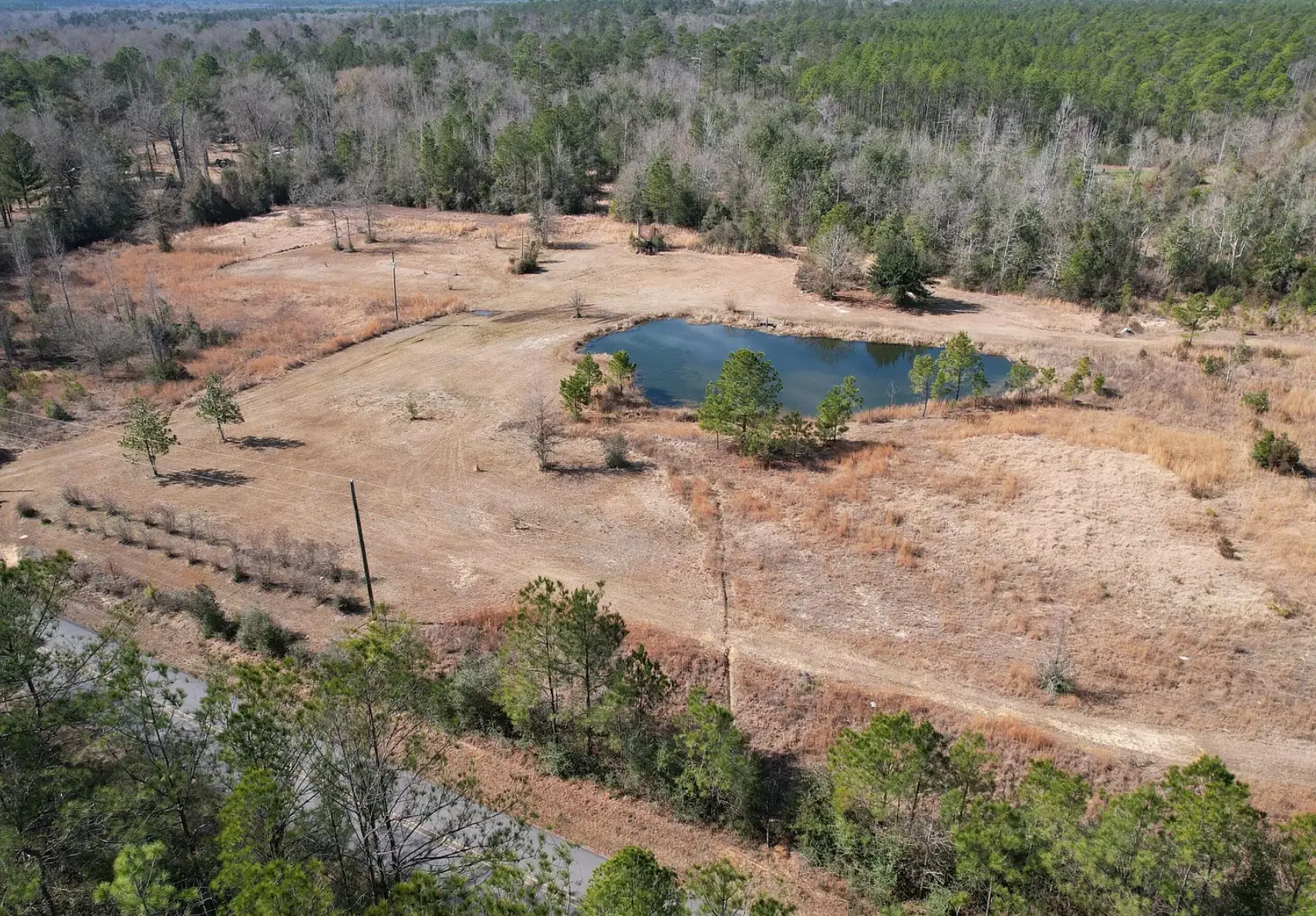 Aerial view of 11 acres with a pond in Perkinston, Stone County, Mississippi